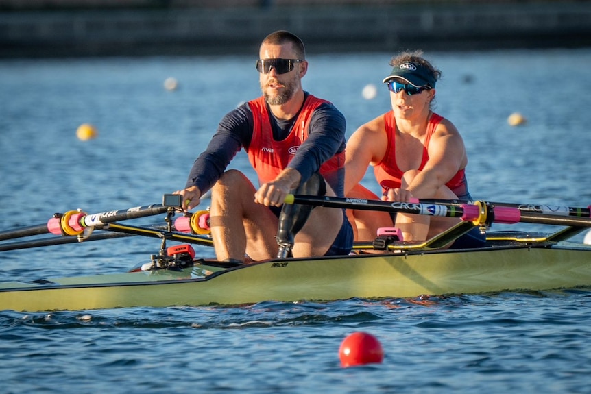 Two rowers in a boat on the water.