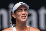 A Spanish female tennis player grimaces during an Australian Open match.