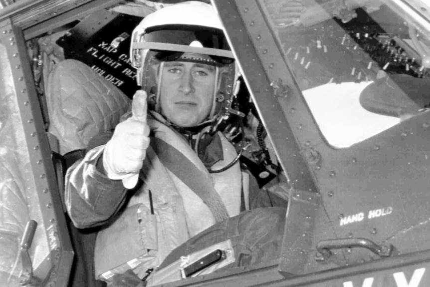 Prince Charles gives a thumbs-up sign as he prepares to take off in a helicopter