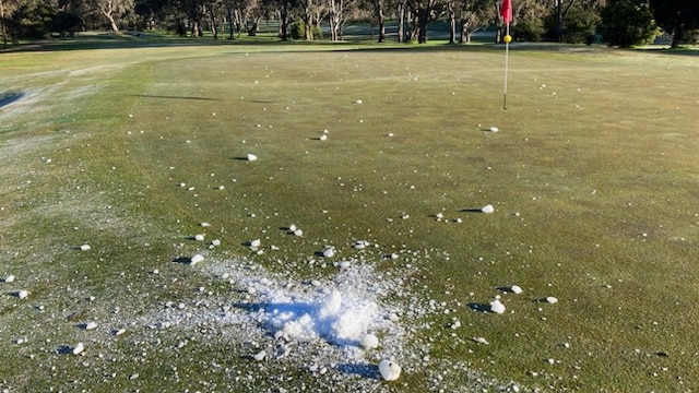 Ice near one of the holes on a golf course.
