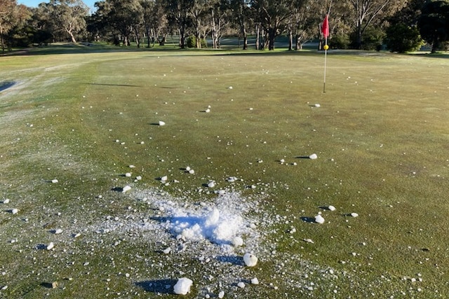Ice near one of the holes on a golf course.