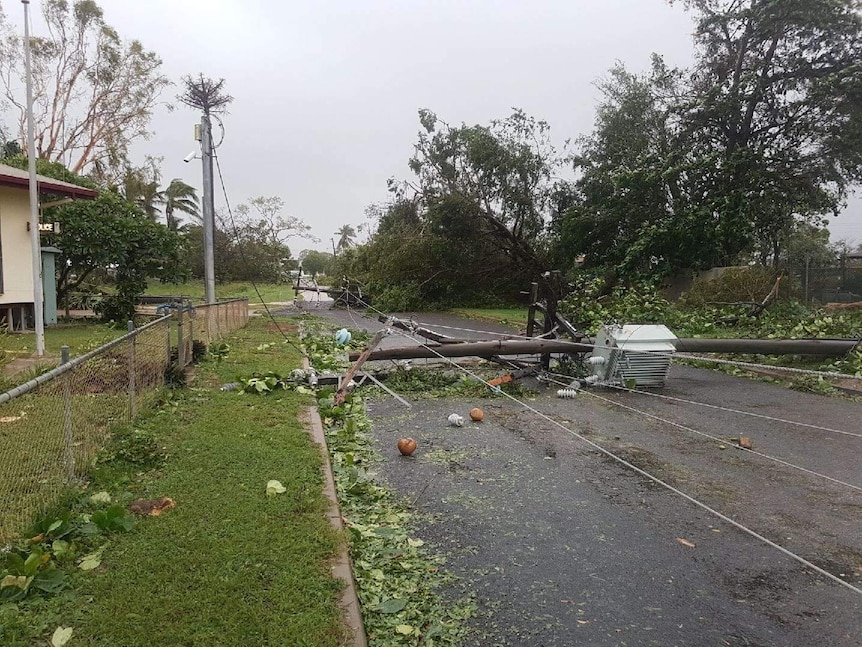 Long strands of electrical power lines crashed down across a road