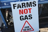 A sign that read: "FARMS NOT GAS. LOCK THE GATE"