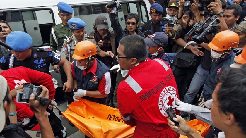 Rescue workers remove a body from the JW Marriot hotel in Jakarta after an explosion on July 17, 200