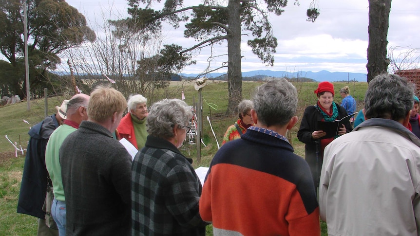 A choir sings and welcomes spring at a wassail ceremony.