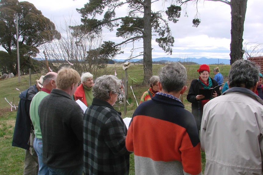 A choir sings and welcomes spring at a wassail ceremony.