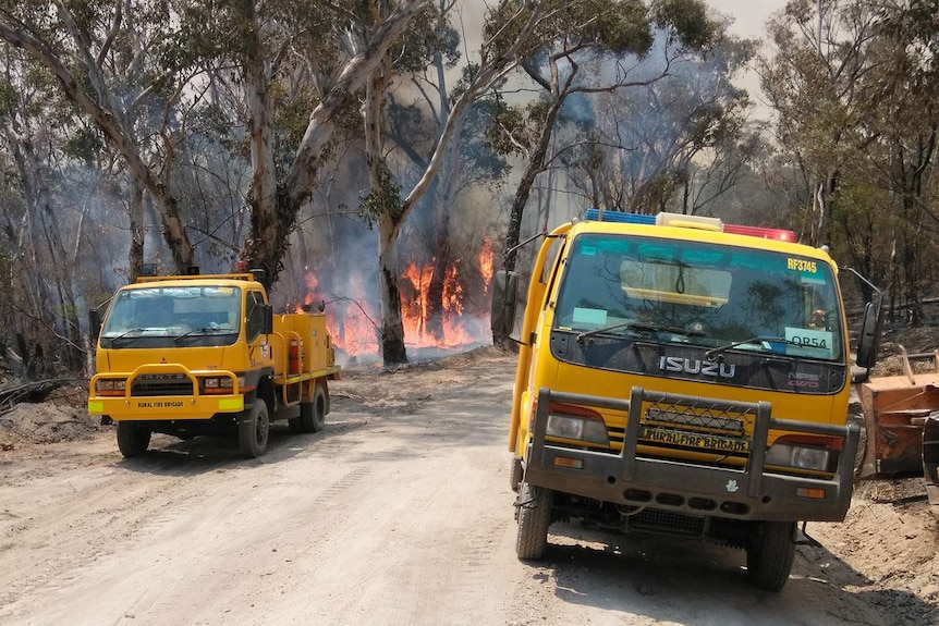 Two trucks belonging to a volunteer rural firefighter crew fighting a bushfire.