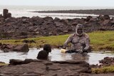 David Djalangi sits in a pool of water on Elcho Island