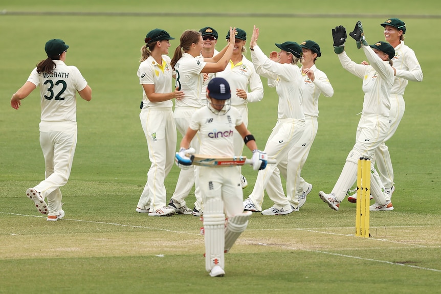 The Australians celebrate as Lauren Winfield-Hall walks away from the crease
