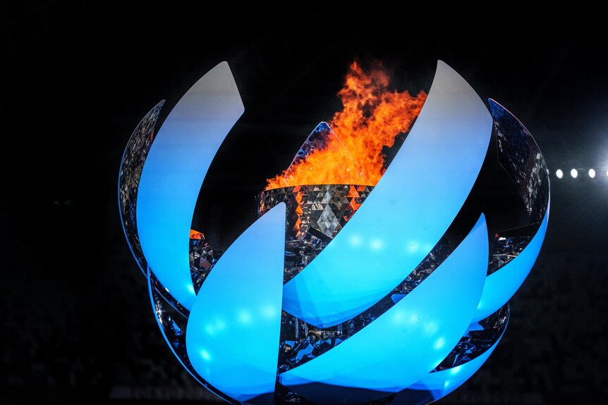 Flame burns inside the Paralympic Cauldron, a structure made of multiple curved metal pieces.