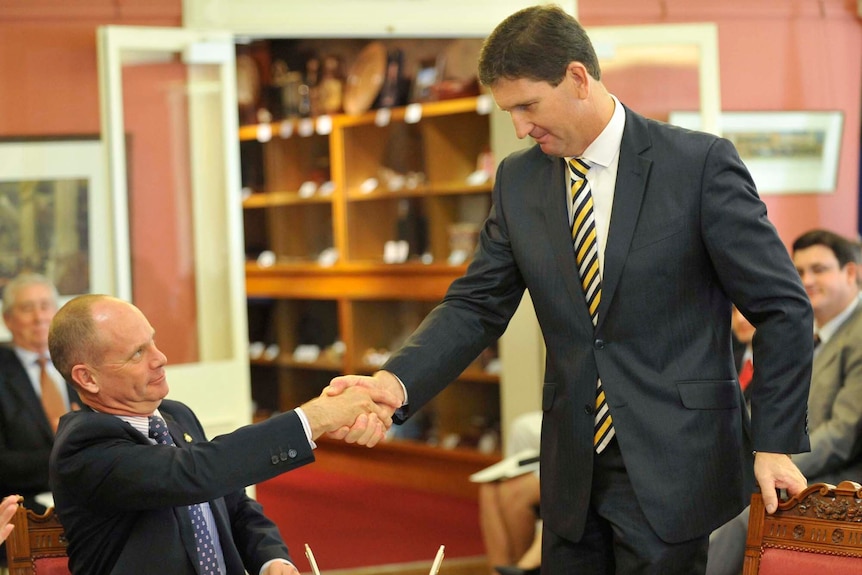 Queensland Premier Campbell Newman (left) shakes hands with Lawrence Springborg, the new Minister for Health