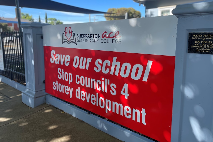 A sign in front of a school