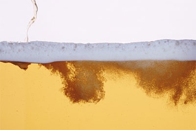 Close-up of a beer being poured