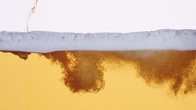 Close-up of a beer being poured