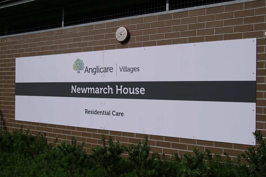 a sign reading anglicare villages newmarch house residential care