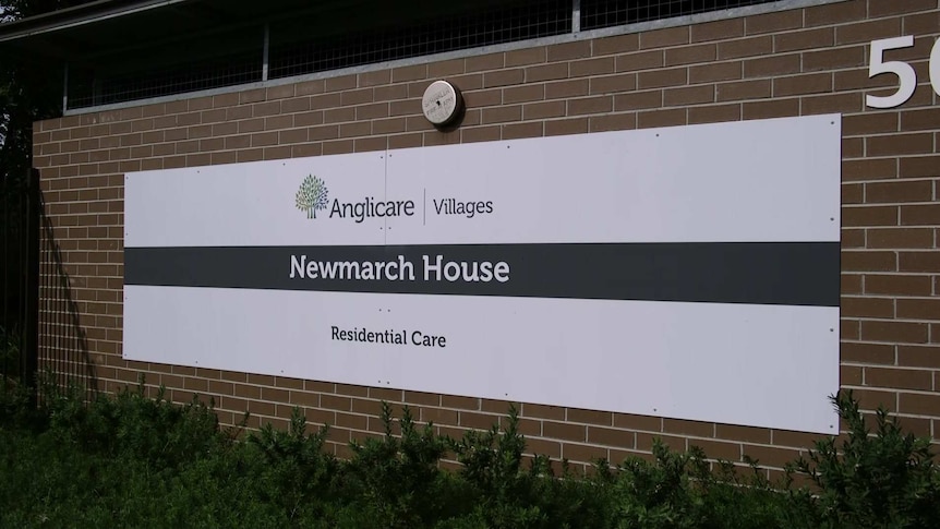 a sign reading anglicare villages newmarch house residential care