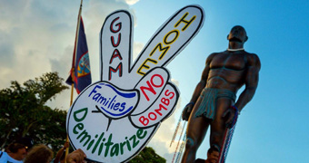 Guam protestor holds sign demanding peace in public rally in response to North Korean crisis.