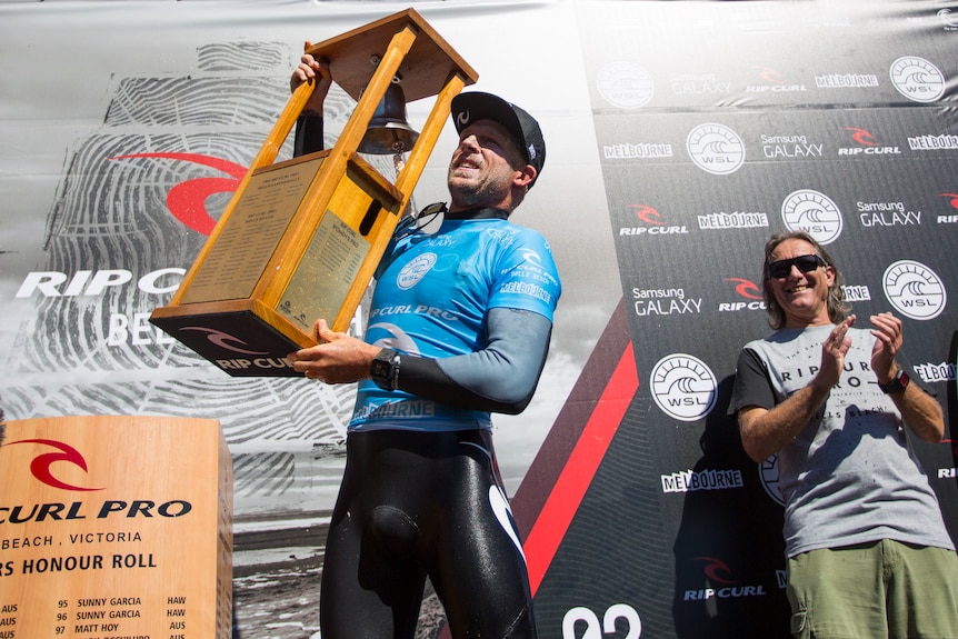 An Australian male surfer with the Bells Beach trophy in 2015.