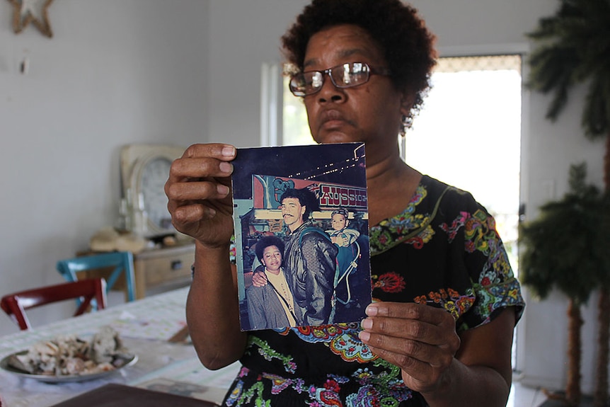 Janeen Prior holding an old photograph of her and her husband, Gary.