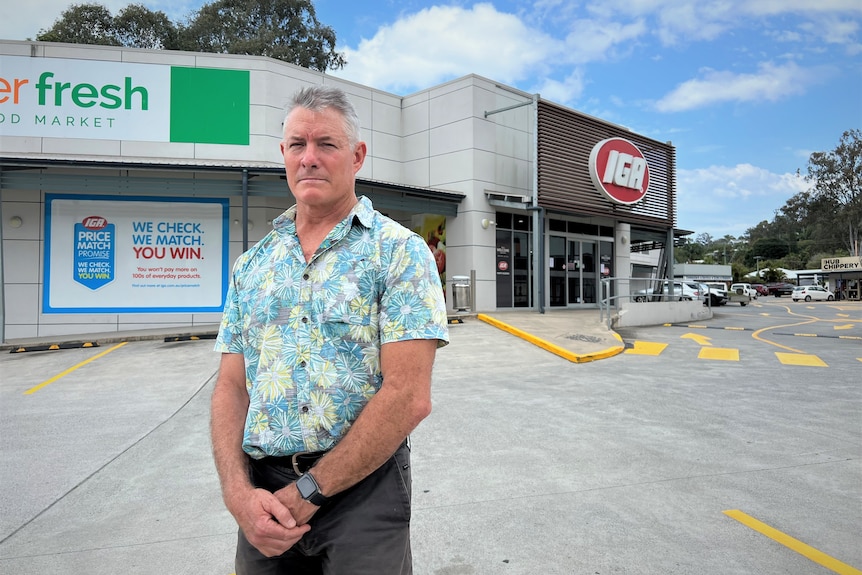Man standing out the front of IGA supermarket
