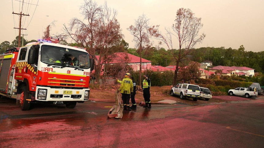 A truck and several houses, covered in pink dust