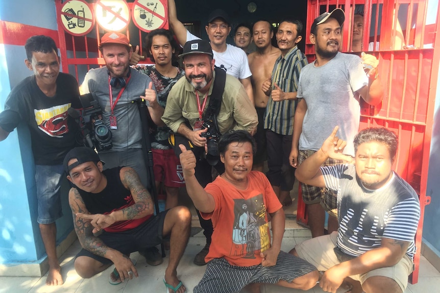 Foreign Correspondent producer/cameraman Matt Davis and cameraman Phil Hemingway with inmates inside Bali's Kerobokan prison