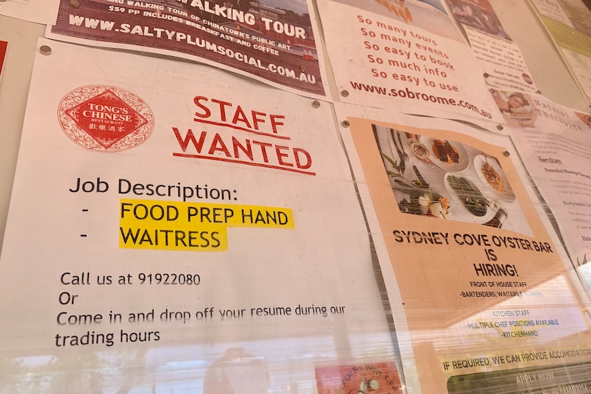 Printed advertisements to recruit staff pinned on a noticeboard