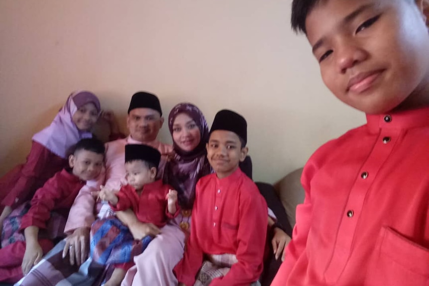 A family of seven wearing red