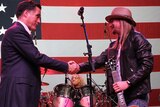 Mitt Romney greets musician Kid Rock at rally