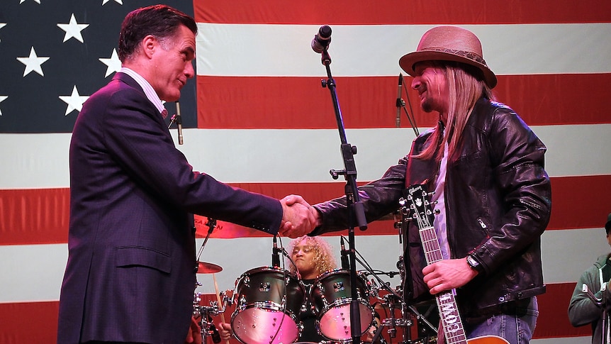 Mitt Romney greets musician Kid Rock at rally