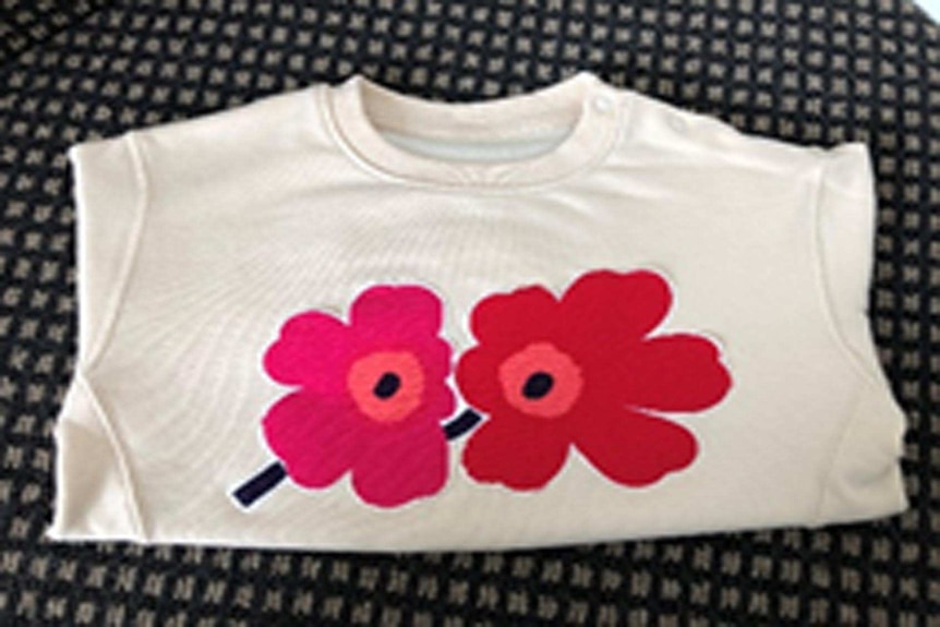 Handmade flower motif on childrens hand-me-down jumper