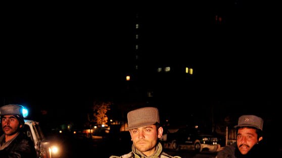 Afghan policeman stands guard
