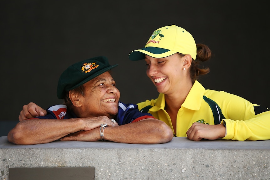 Ash Gardner and Faith Thomas look at each other and smile, as Gardner has her arm around Thomas' shoulder