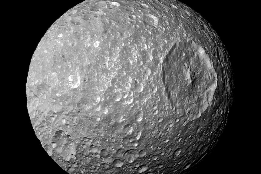 A moon with a very rough surface is pictured.