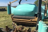 A silage wrapper covering bales on a property in the Riverina