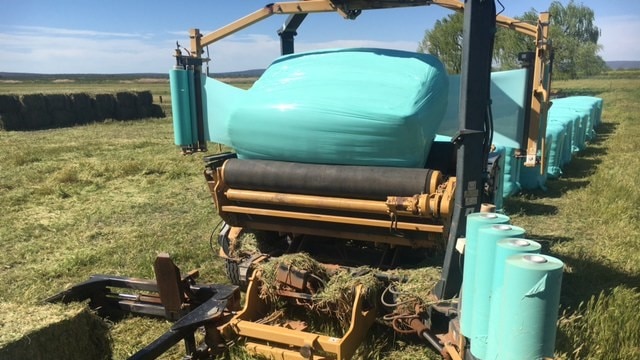 A silage wrapper covering bales on a property in the Riverina