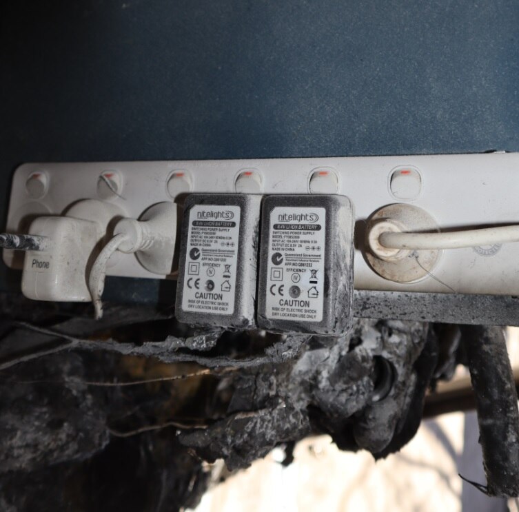 An electrical power board with burned material nearby