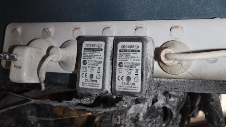 An electrical power board with burned material nearby