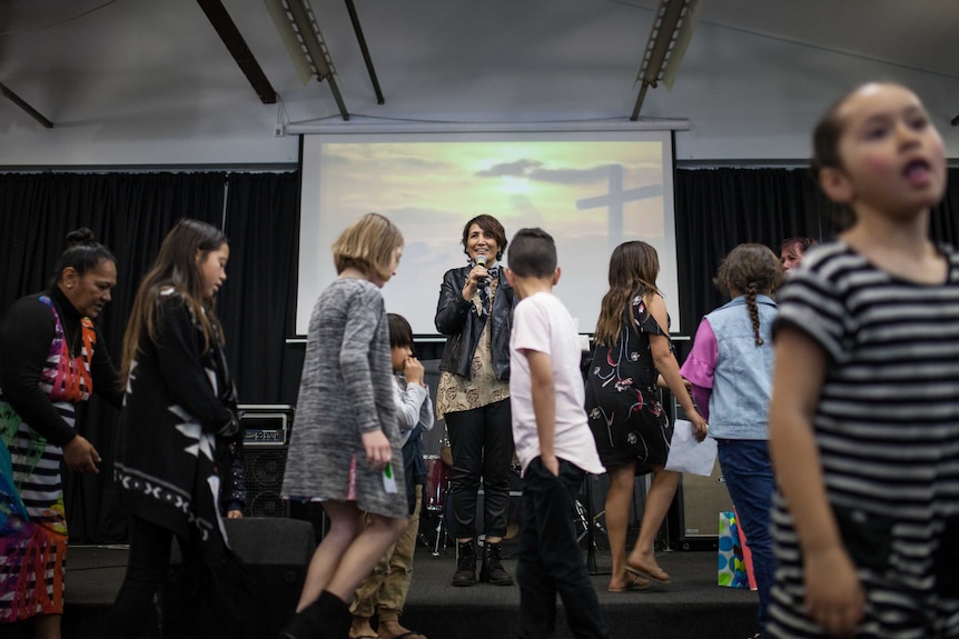 Children gather on stage at a church service in Kalgoorlie, WA.