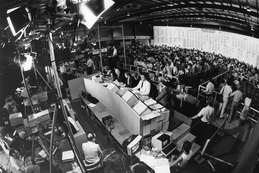 Aerial shot of the crowded tally room with ABC set in front of tally board.