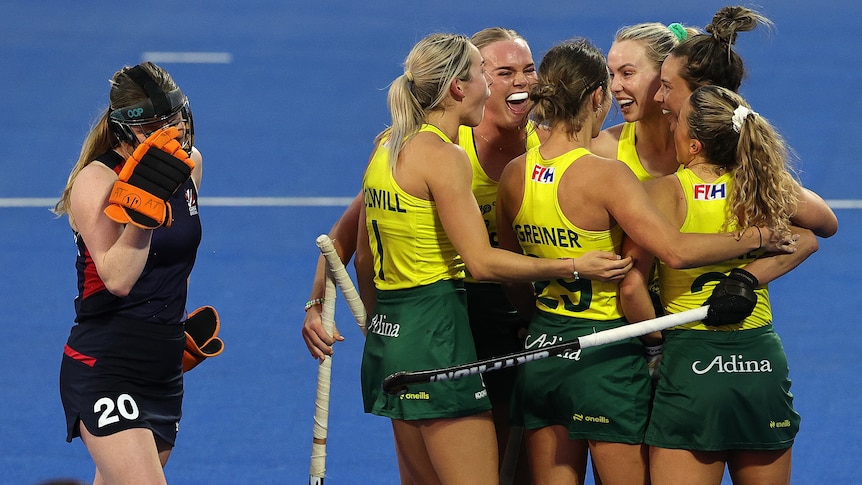 Hockeyroos players celebrate a goal against Great Britain.