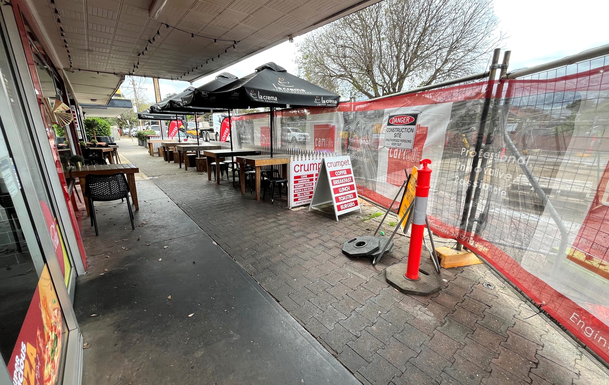 Strip fencing next to cafe tables