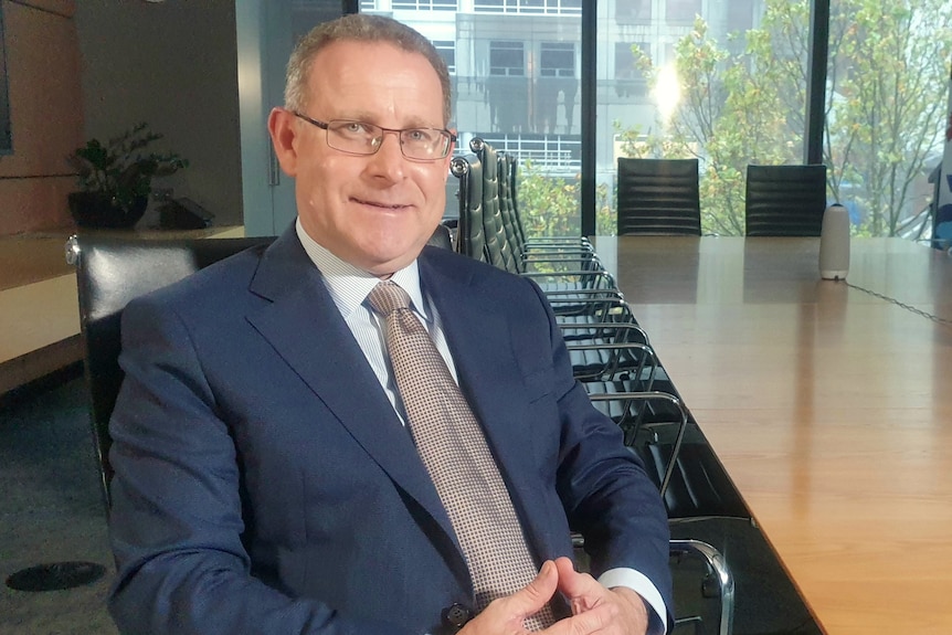 Andrew McKellar in a blue suit at ACCI's Melbourne office ahead of the May 21 federal election.