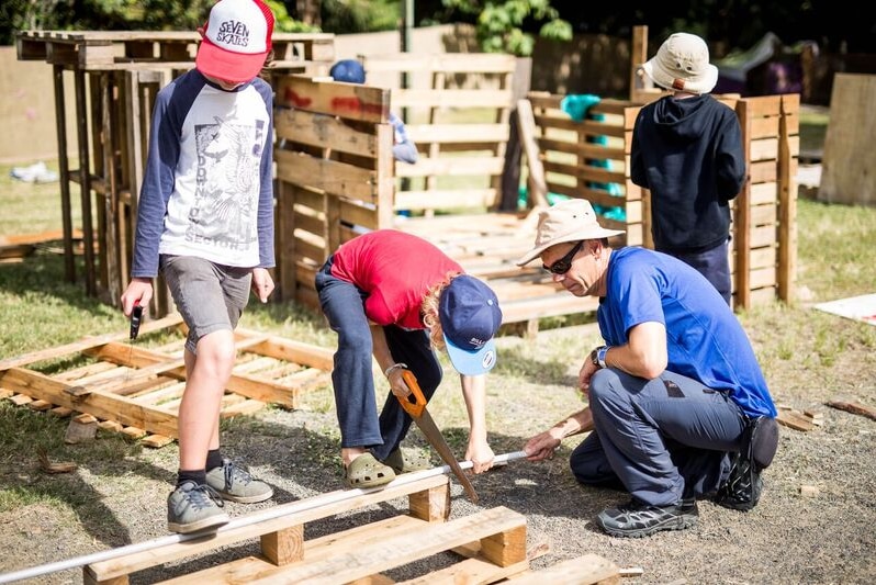 A boy saws wood