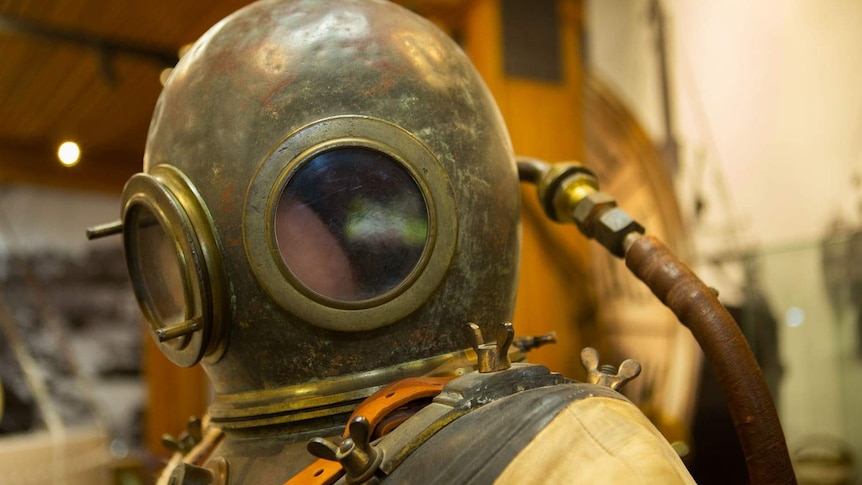 close up of an early 20th century diiving suit and heavy brass helmet