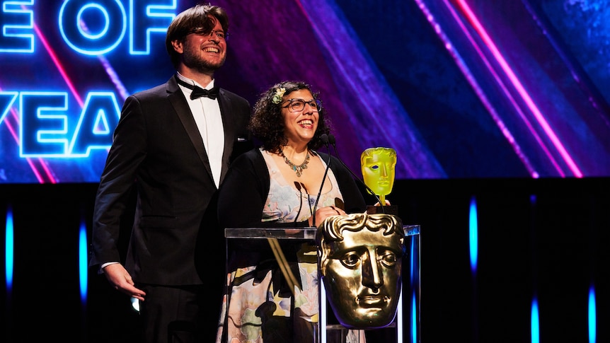Tim Dawson and Wren Brier on stage at the BAFTAs after winning. 