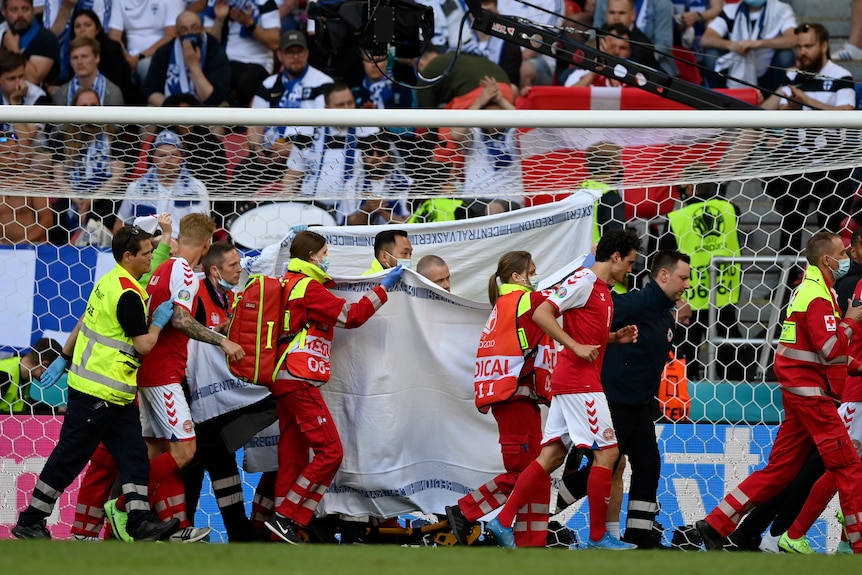Denmark's Christian Eriksen is taken away on a stretcher after collapsing on the pitch