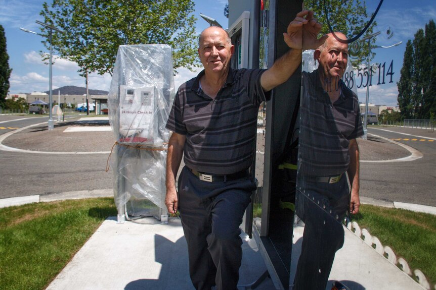 A man leans against a van.