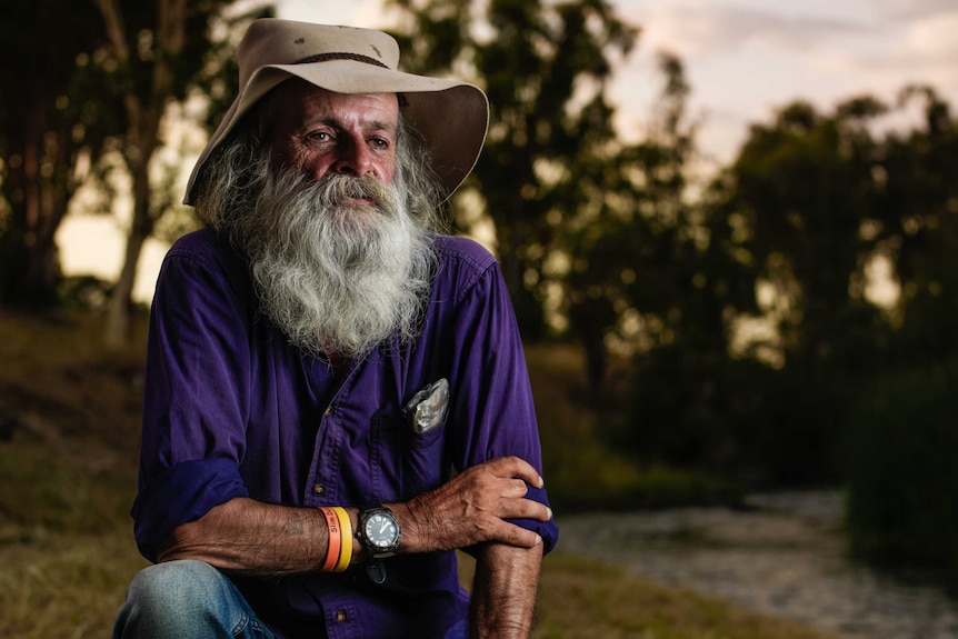 A bush poet with a tobacco stained long white beard and well worn hat