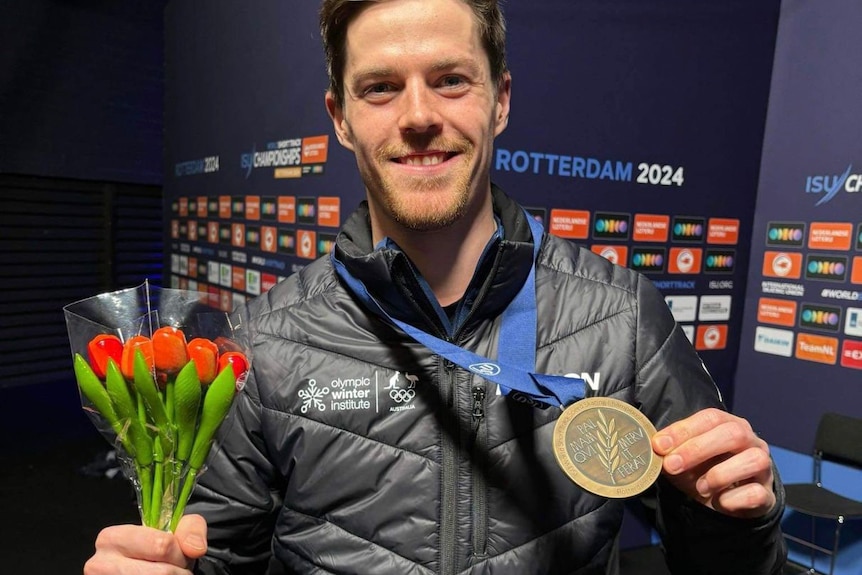 Brendan Corey holds his medal